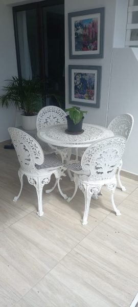 Wrought iron furniture for dining outdoors was inherited from a dear friend.