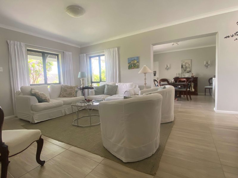 Open plan living space with lounge flowing into the dining area.