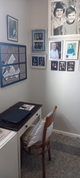 Study which serves as an administrative hub with pinboard and a gallery of personal family photos