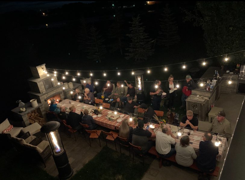 Outdoor kitchen and entertaining area during an evening get together.