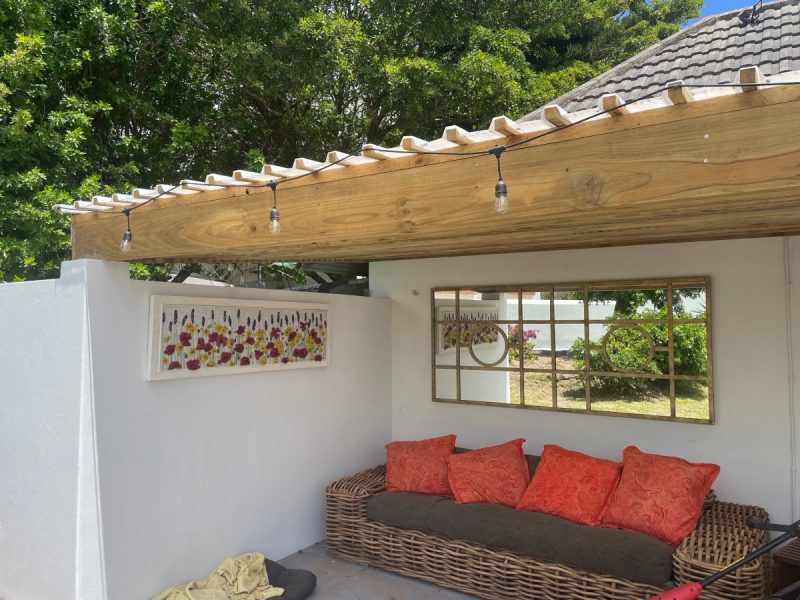 Photo of the under cover seating area at the pool for relaxed moments outdoors.