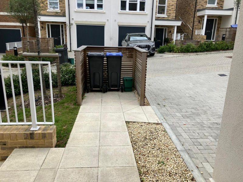 Photo of the refuse bin area with a wooden screen