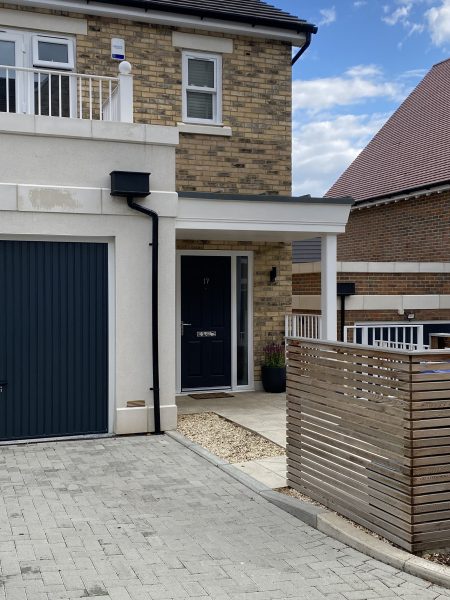 Photo of the entrance with garage and space to park.