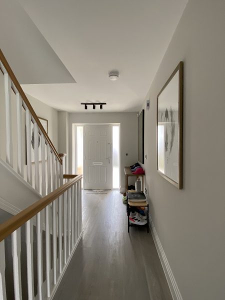 Photo of light flowing in through the hallway from the front door