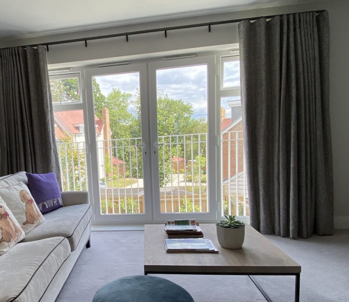 Photo of the spacious doors and window bathing the lounge and office space in light