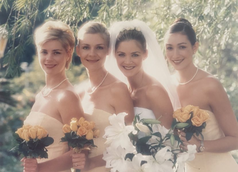 Photo of a bride and bridesmaids with their bouquets