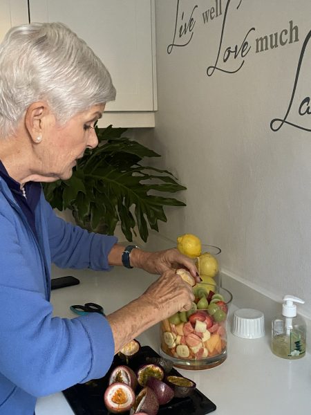 Photo of a woman preparing a fruit salad