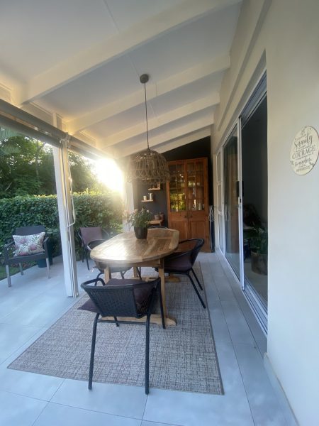 Phot of a verandah with seating area bathed in the morning light