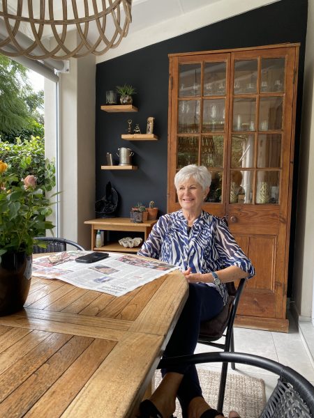 Photo of a lady sitting at a table outdoors