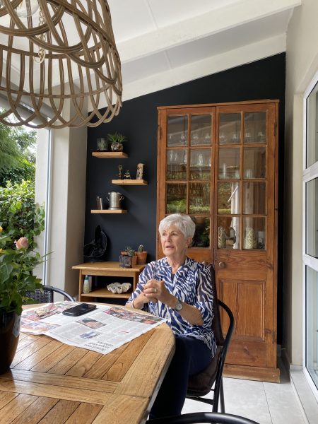 Photo of a lady sitting at a table outdoors